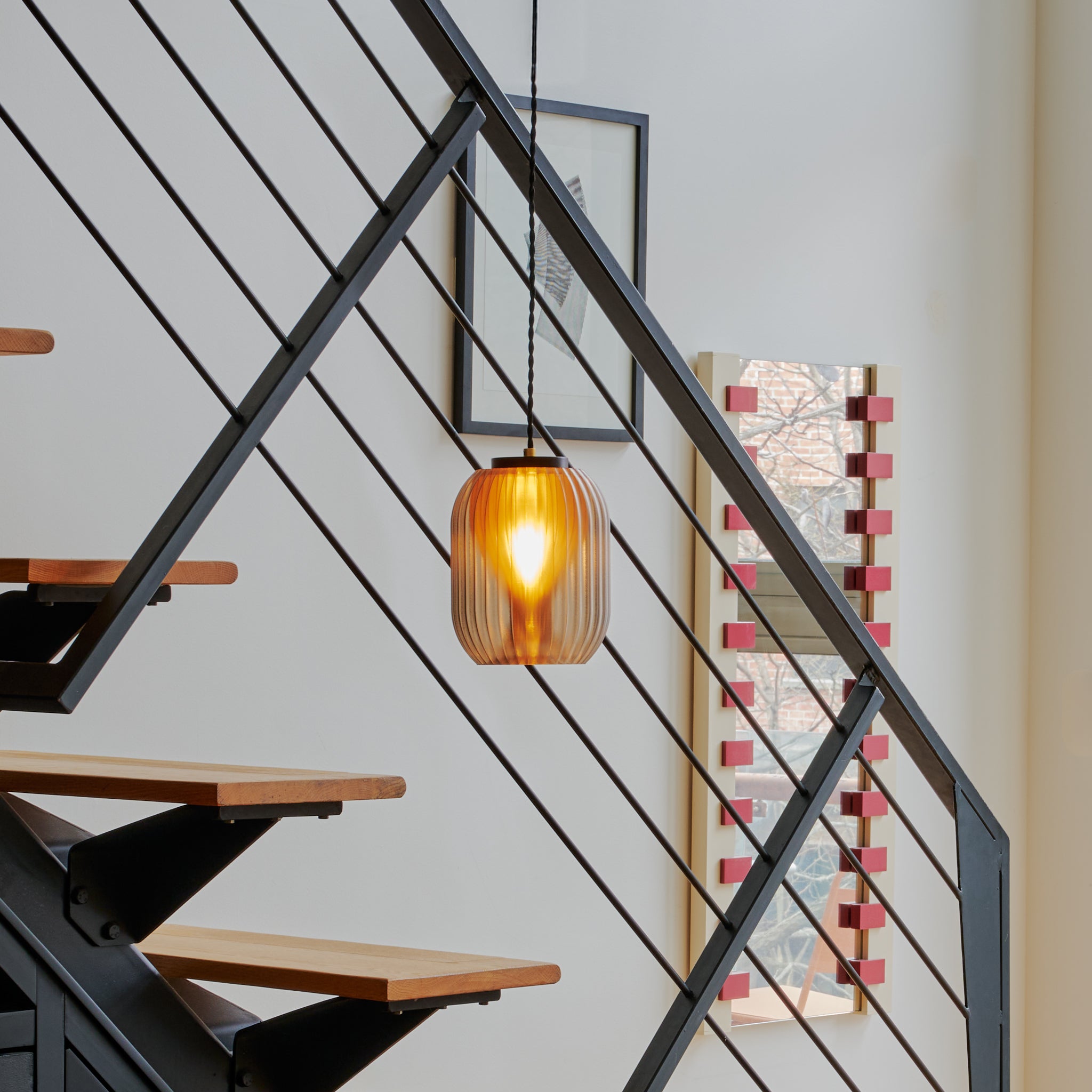 Image of Allium Pendant in front of a modern staircase