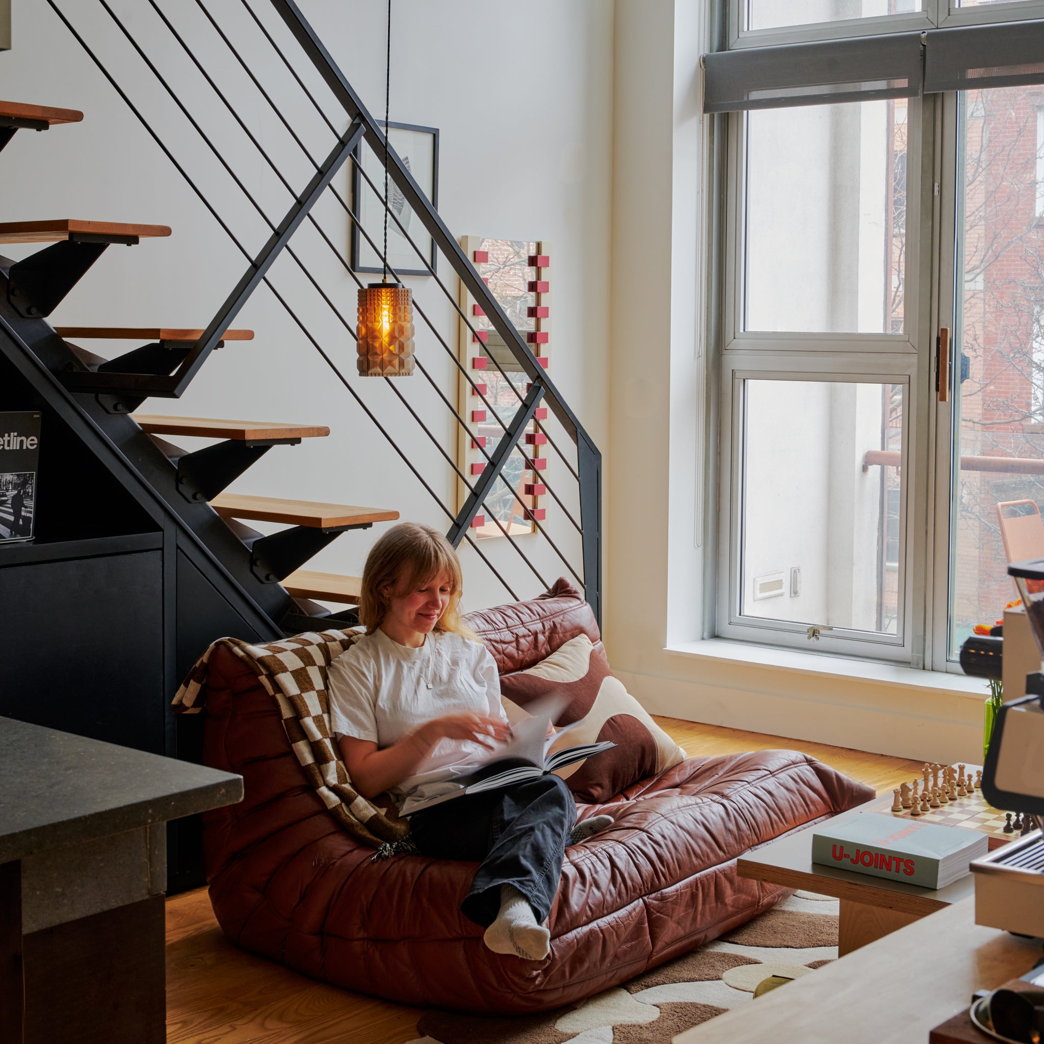 Image of Gem Pendant above woman reading