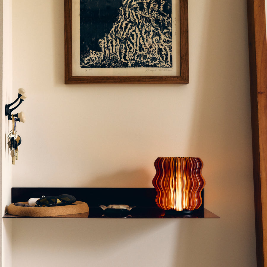 Cordless mini wavy lamp in amber on entryway shelf