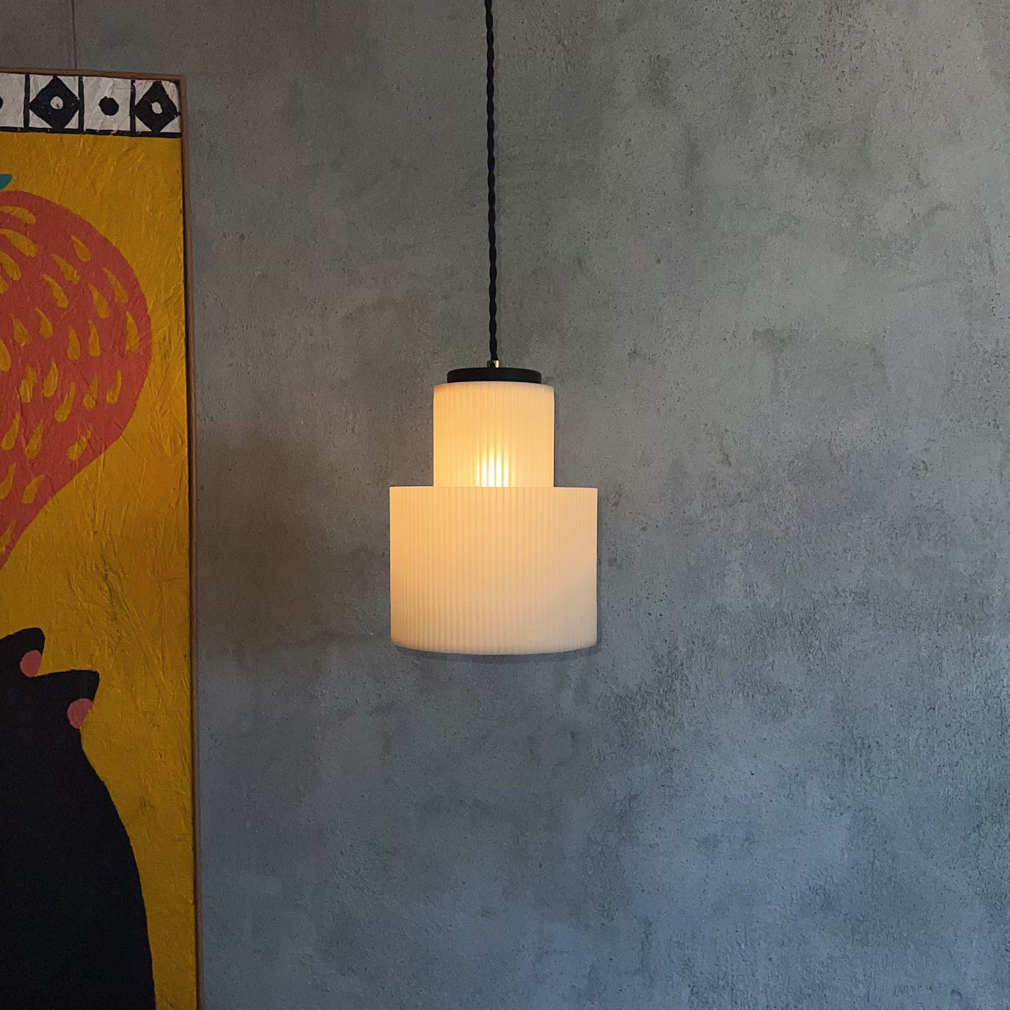 Image of Drum Pendant in front of cement wall in modern living room