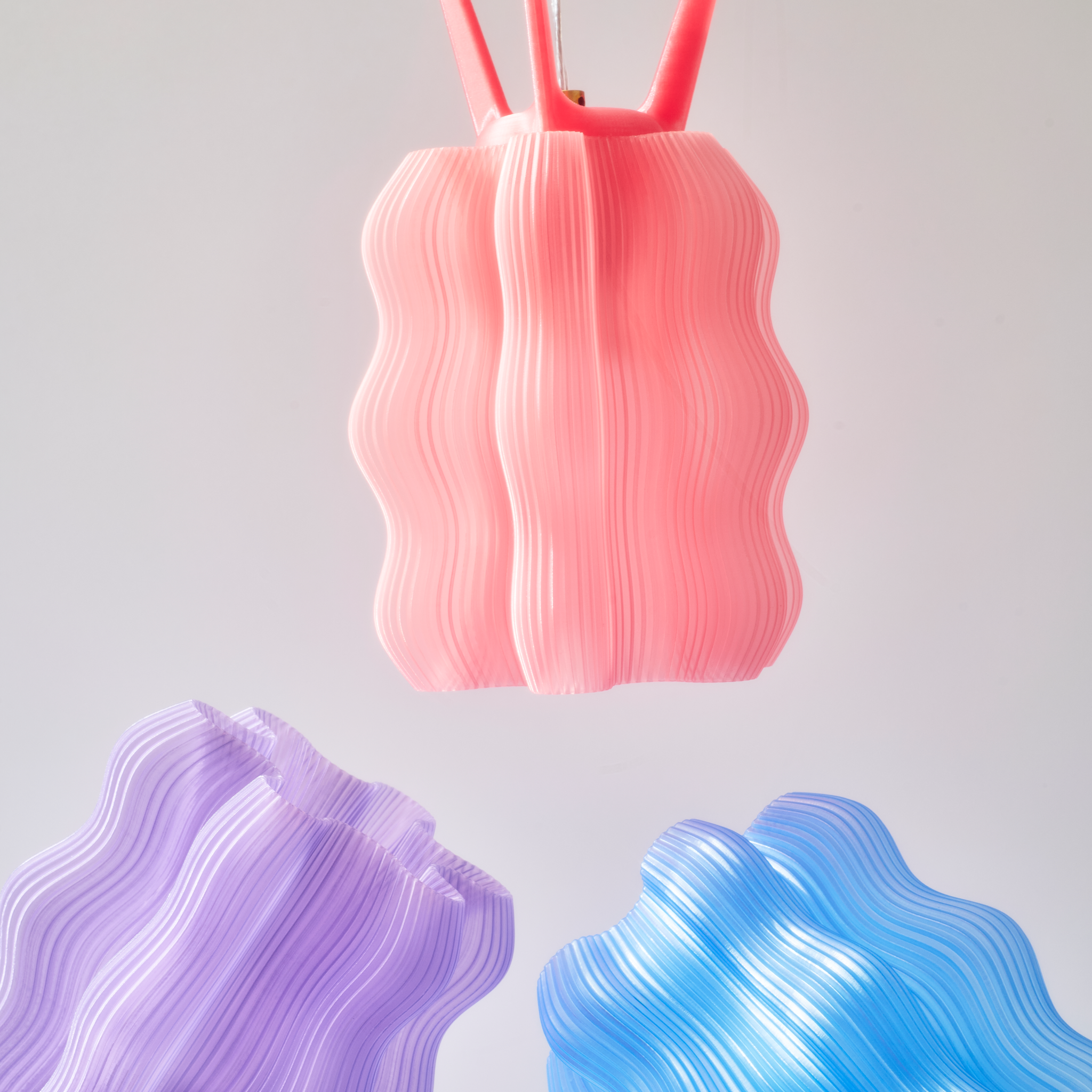 Wavy Lamps in peach, lilac, and periwinkle on white background