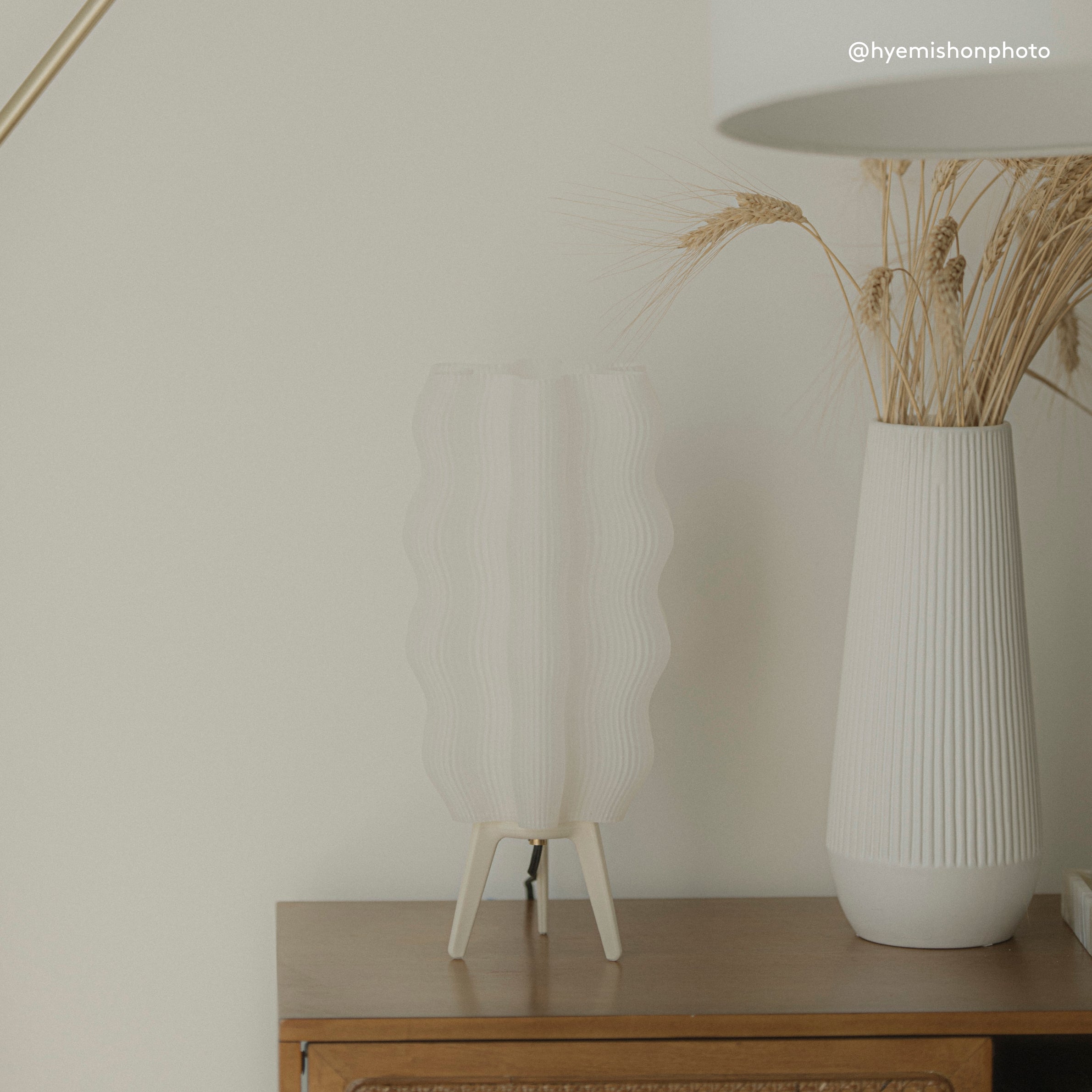 Tall Wavy Lamp in eggshell on side table with vase