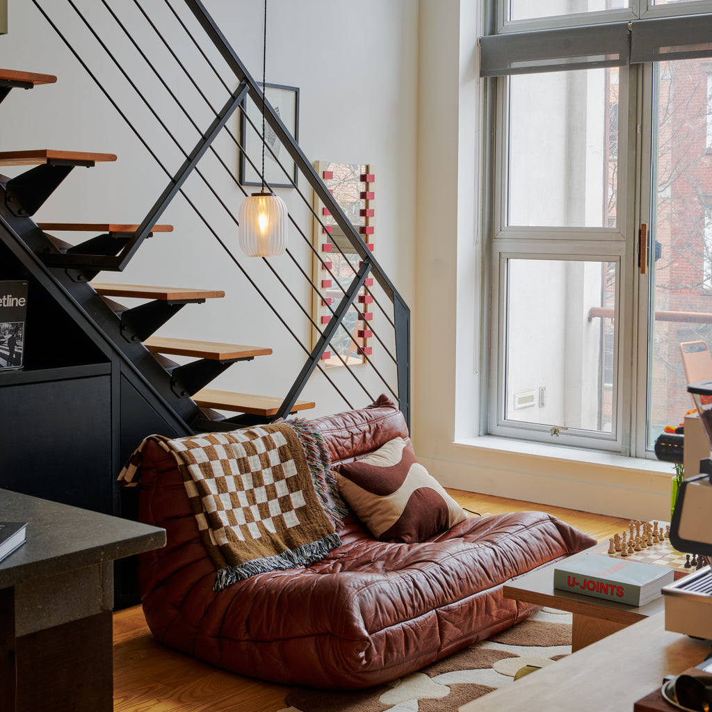 Image of Allium Pendant white above a leather sofa
