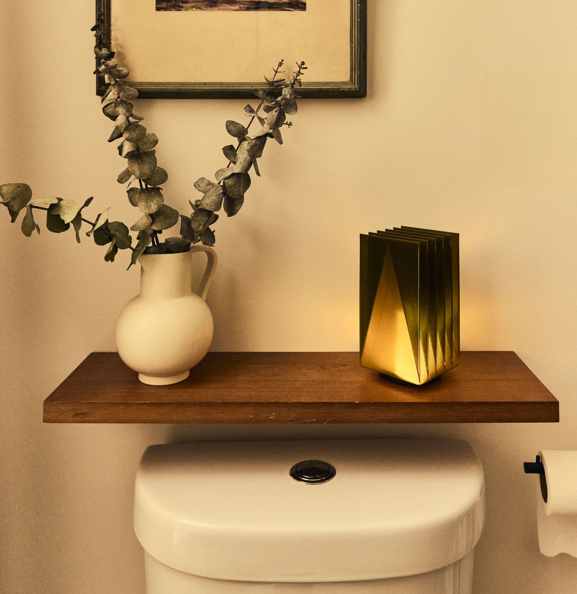Cordless Fin Lamp in Olive Oil on shelf in bathroom