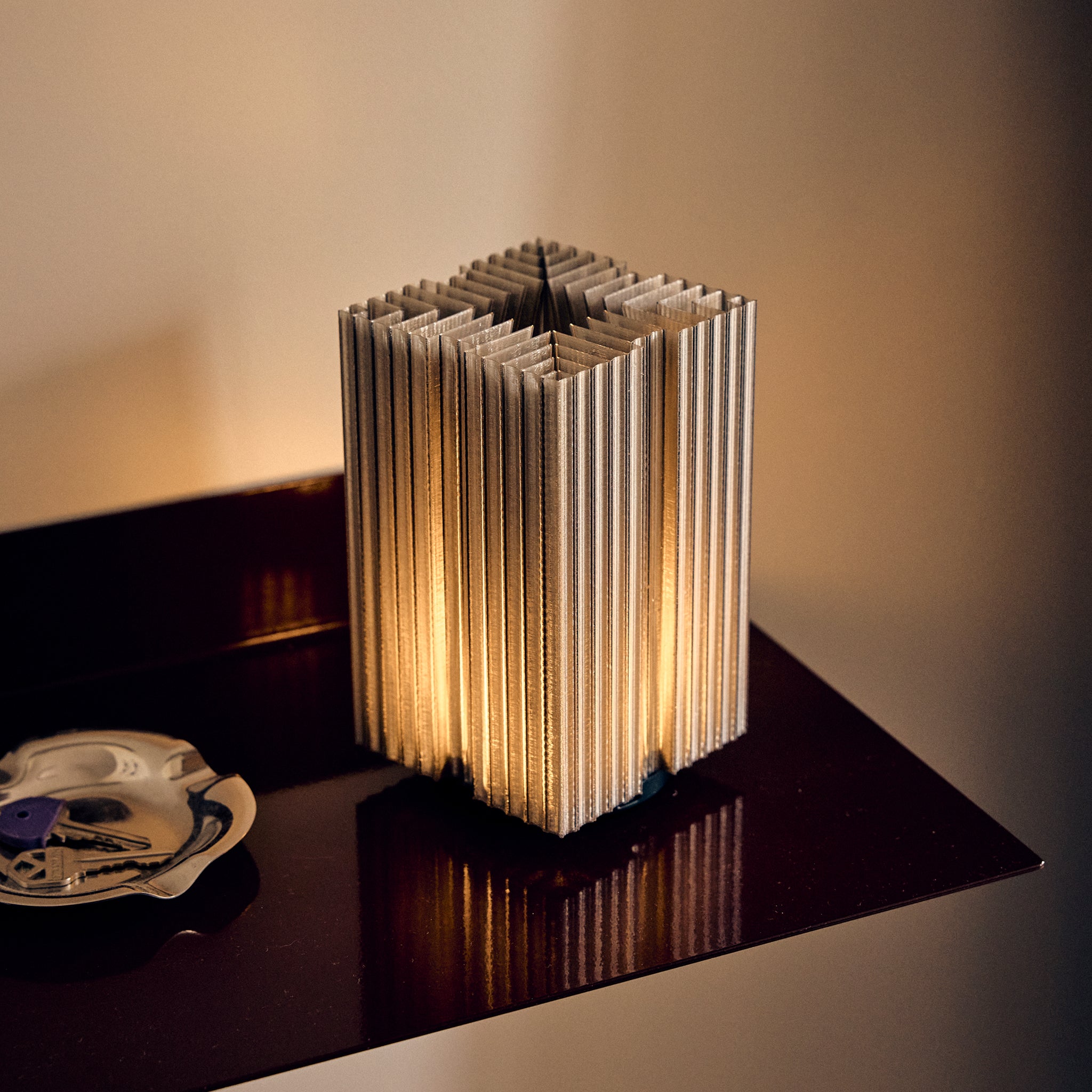 Close up Cordless mini brut lamp in smoke on shelf