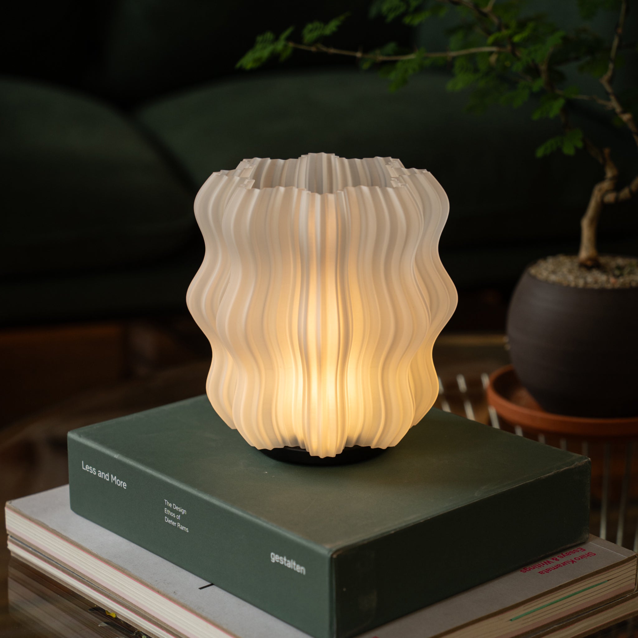 Cordless Mini Wavy Lamp on stack of books