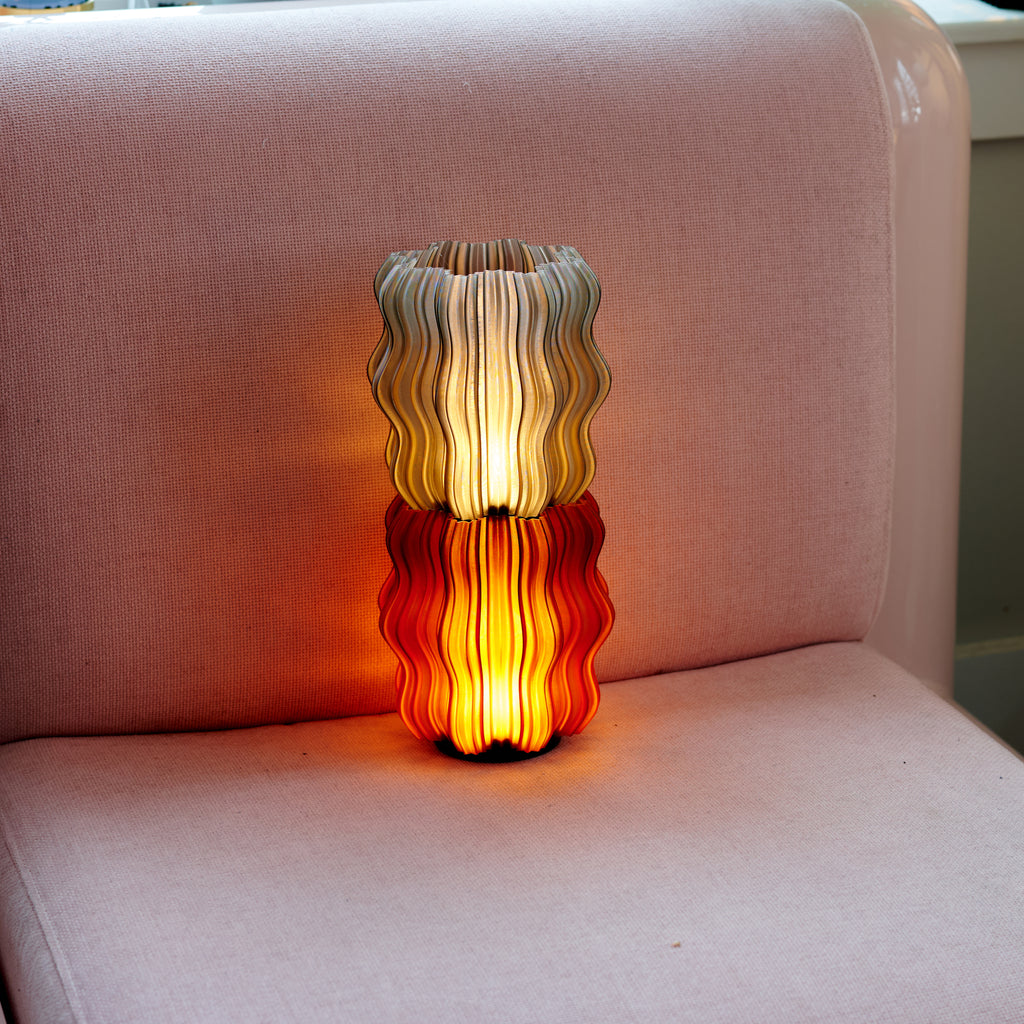 Cordless Mini Wavy Lamps in Amber and Smoke on pink chair