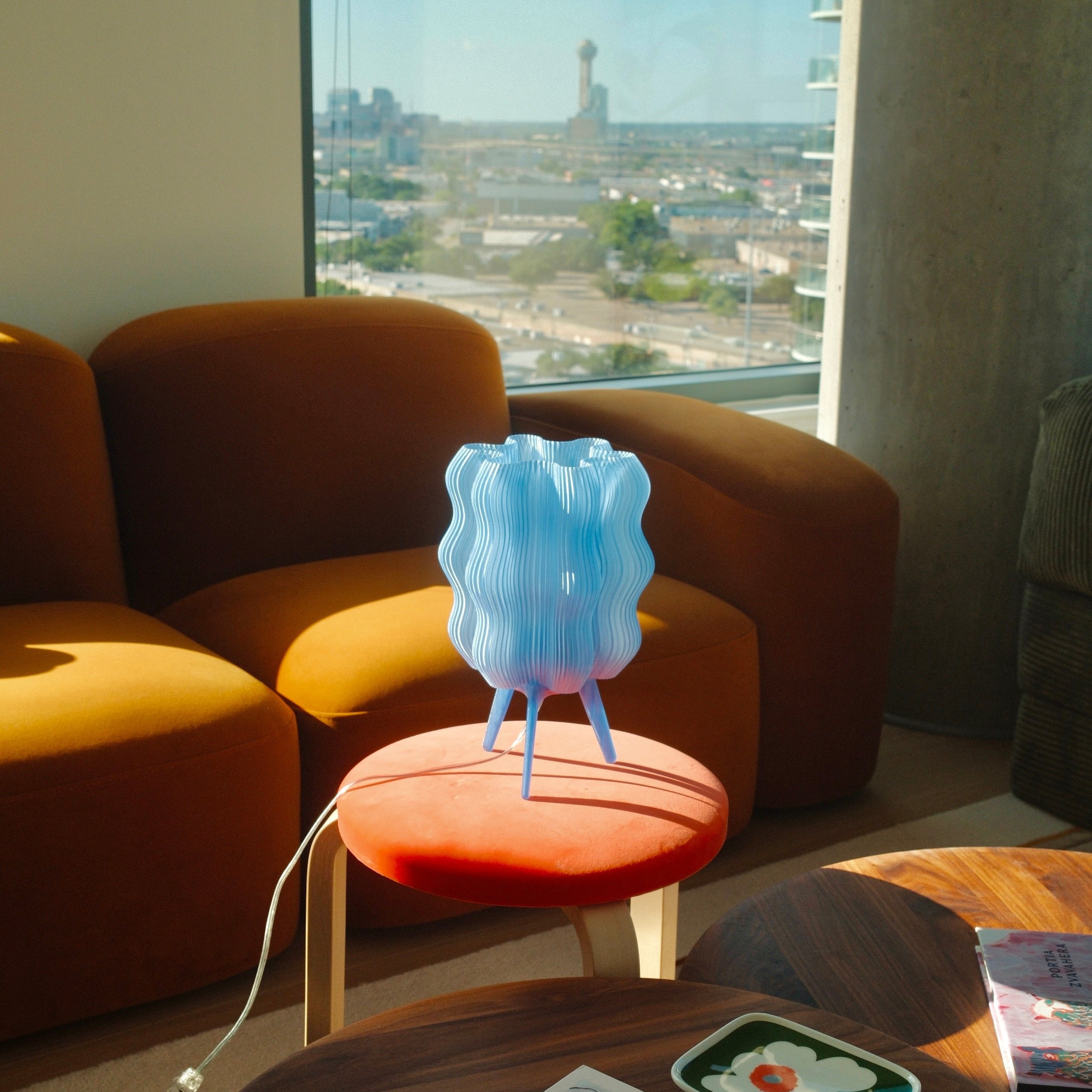 Wavy Lamp in periwinkle on orange table