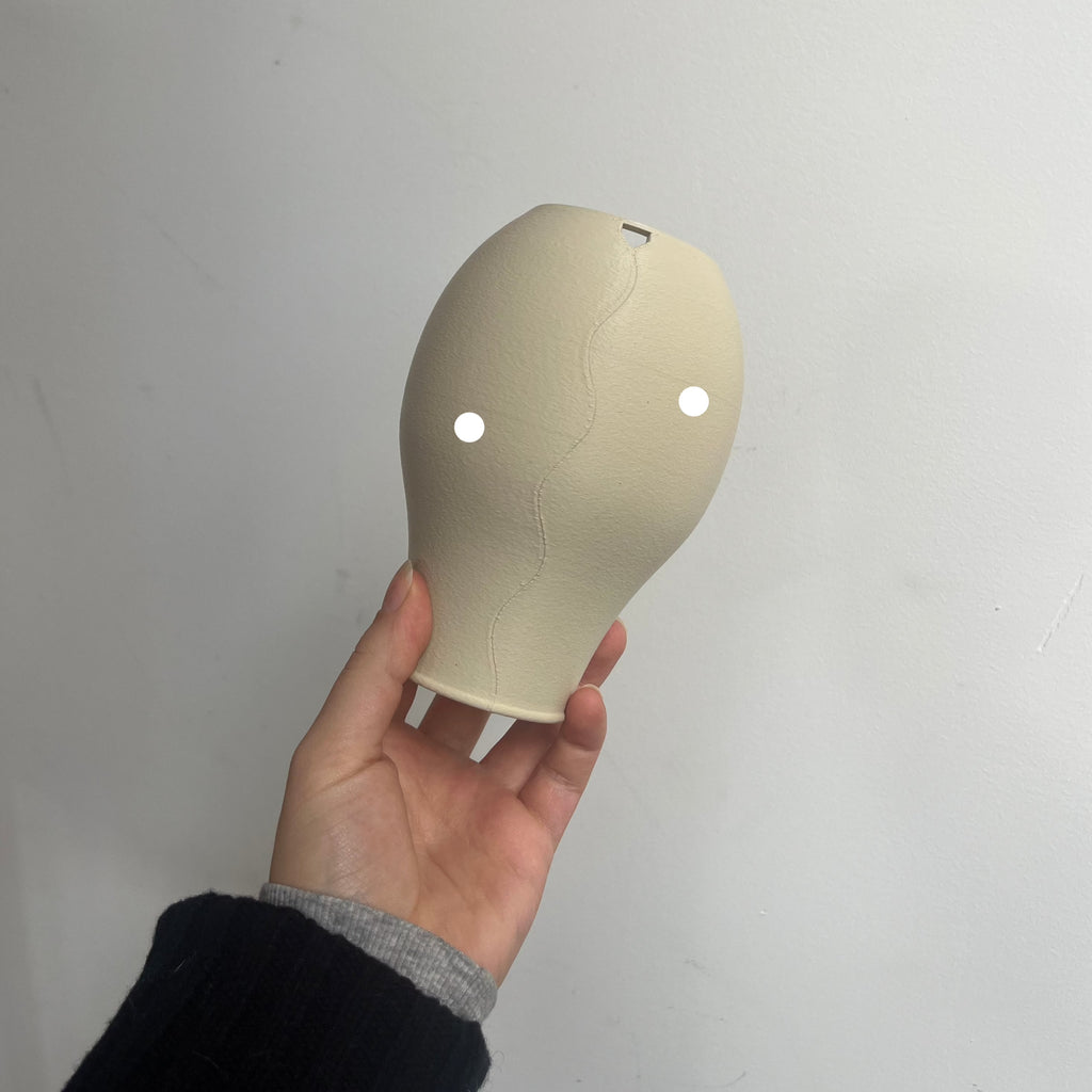 Scoop Lamp in eggshell with defect on white background