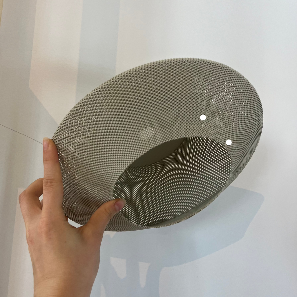 Helios Sconce shade in eggshell with defect on white background