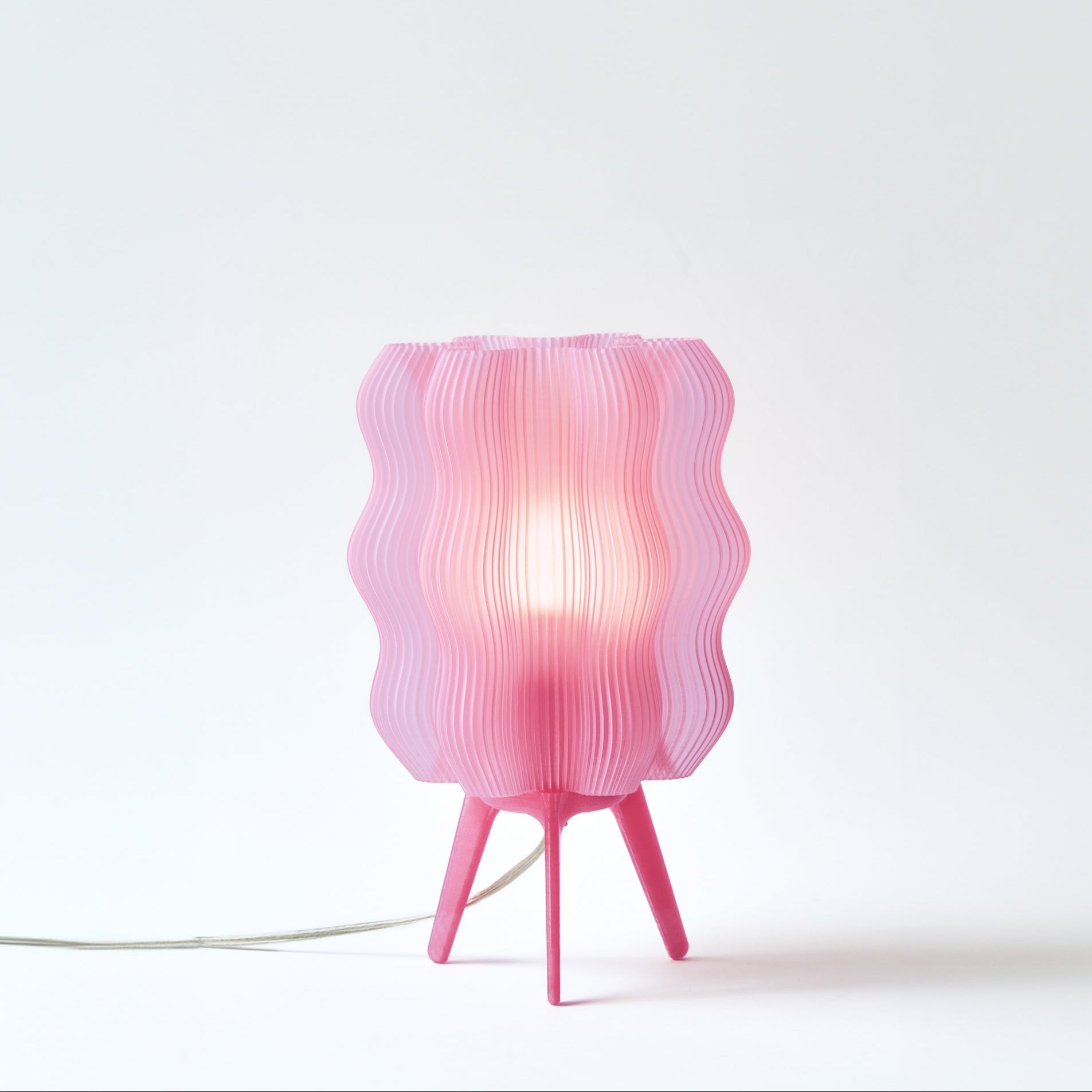 Wavy lamp in pink lemonade on white background