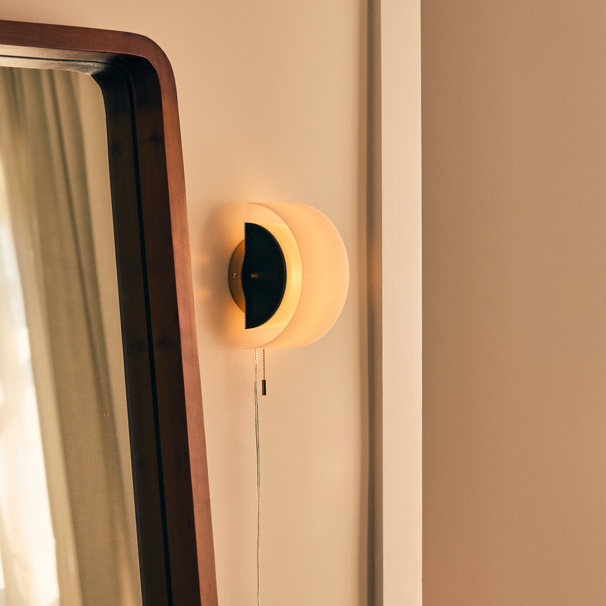 Lina Sconce in natural next to mirror