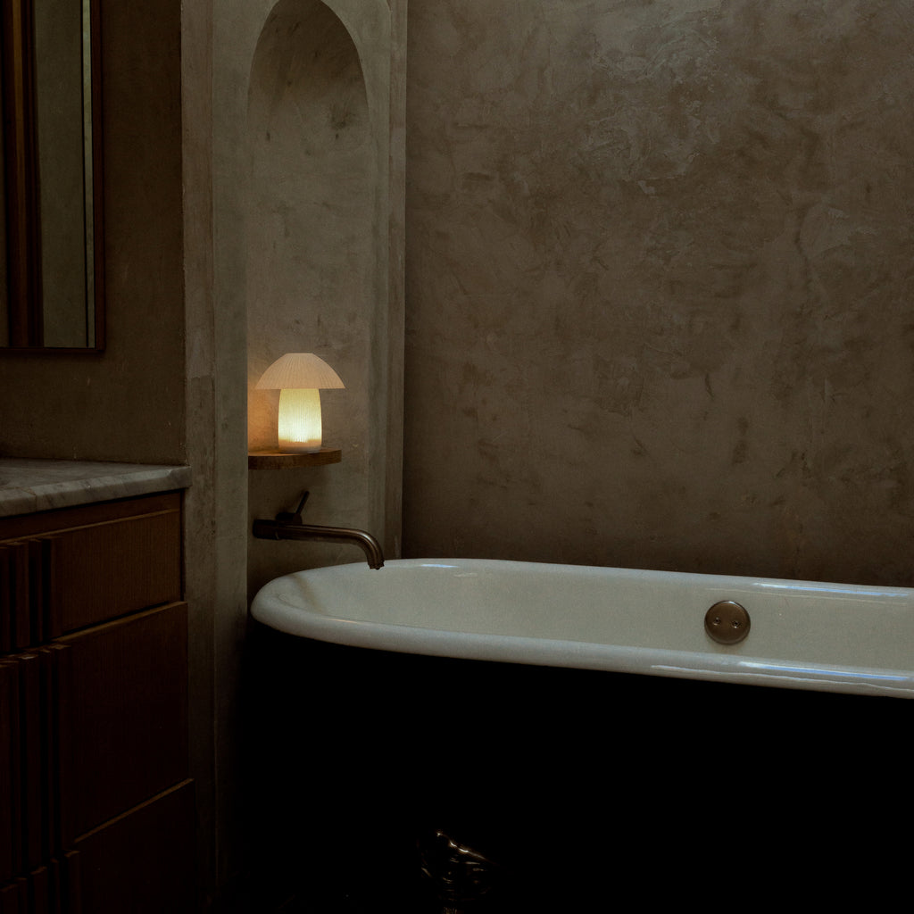 Kinoko cordless lamp next to bathtub