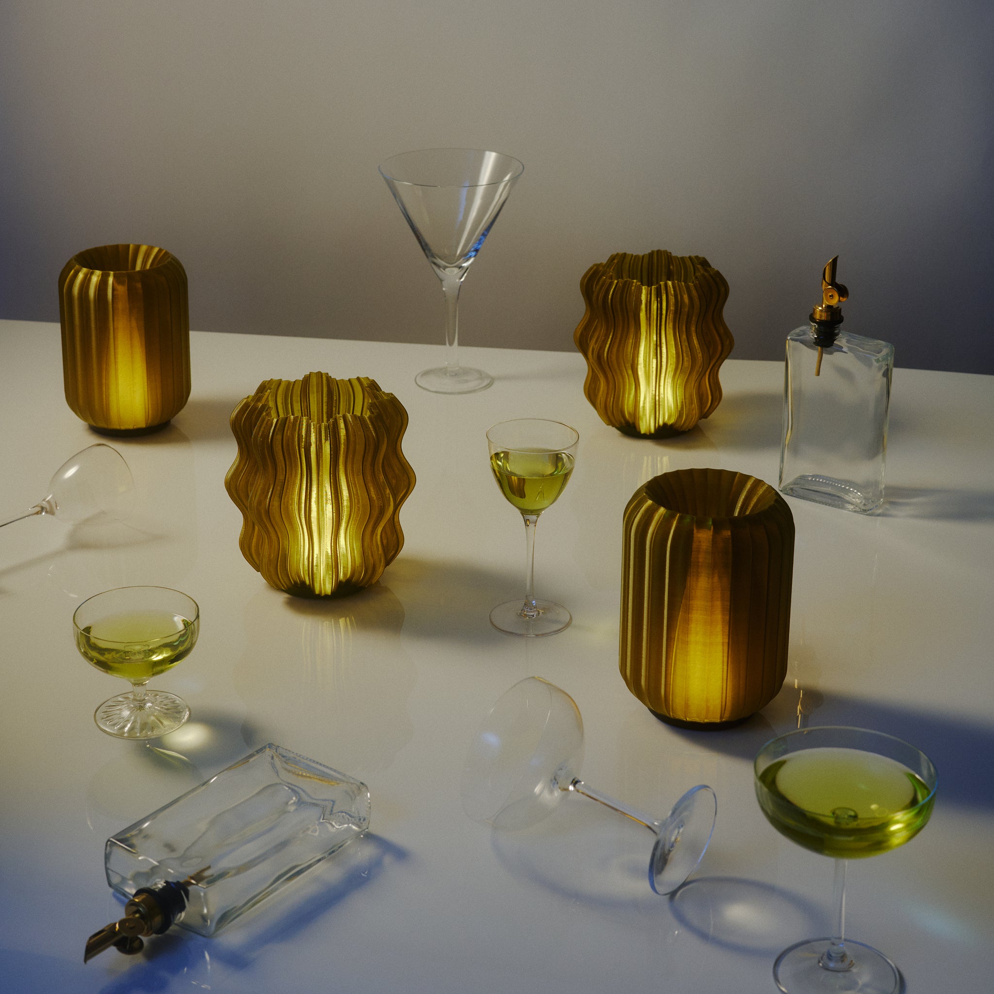 Mini Wavy and Mini Allium Lamps in Olive oil surrounded by martini glasses and olive oil bottles