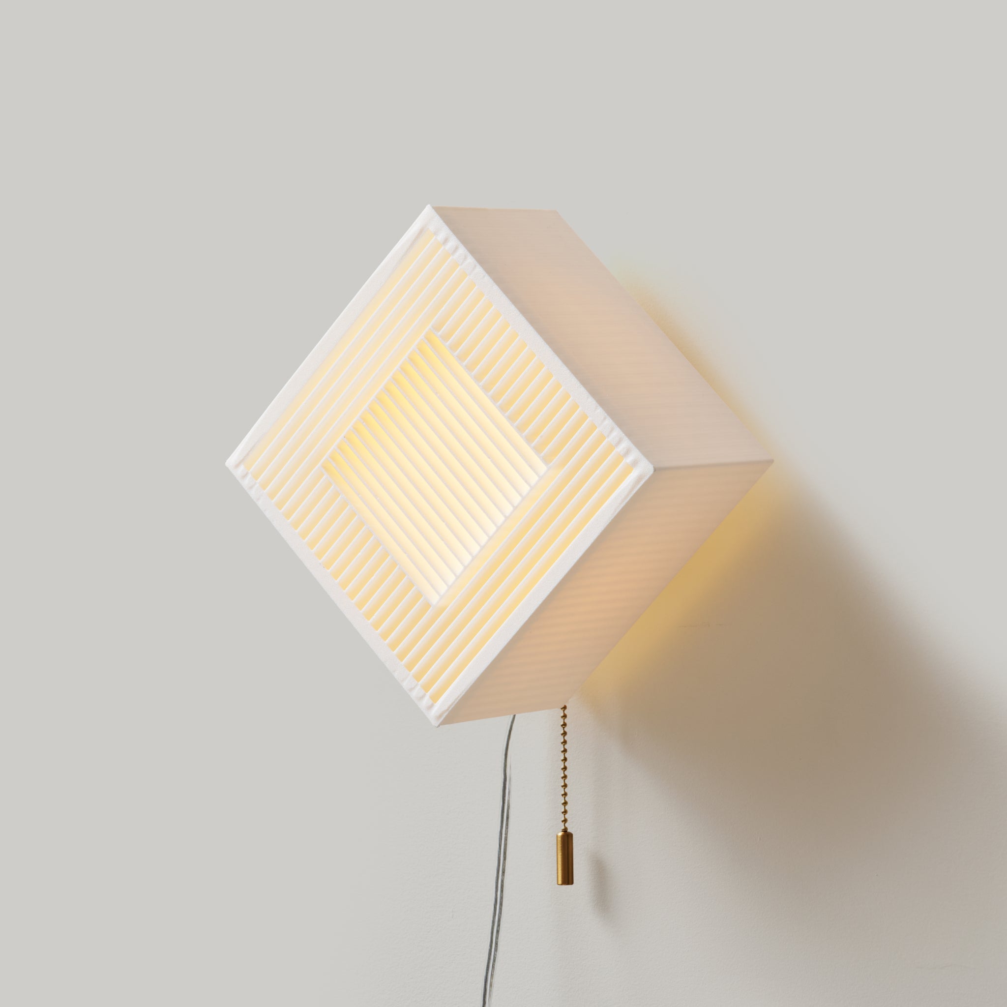 palindrome sconce rotated to diagonal on white background from the side