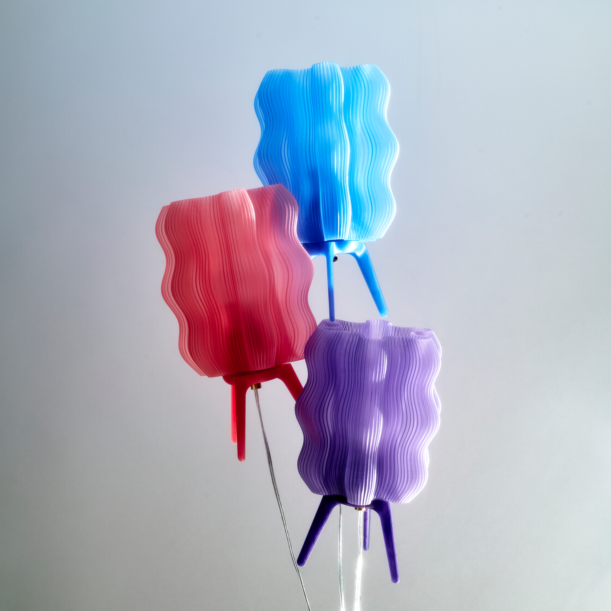 Wavy Lamps in periwinkle, peach, and lilac suspended