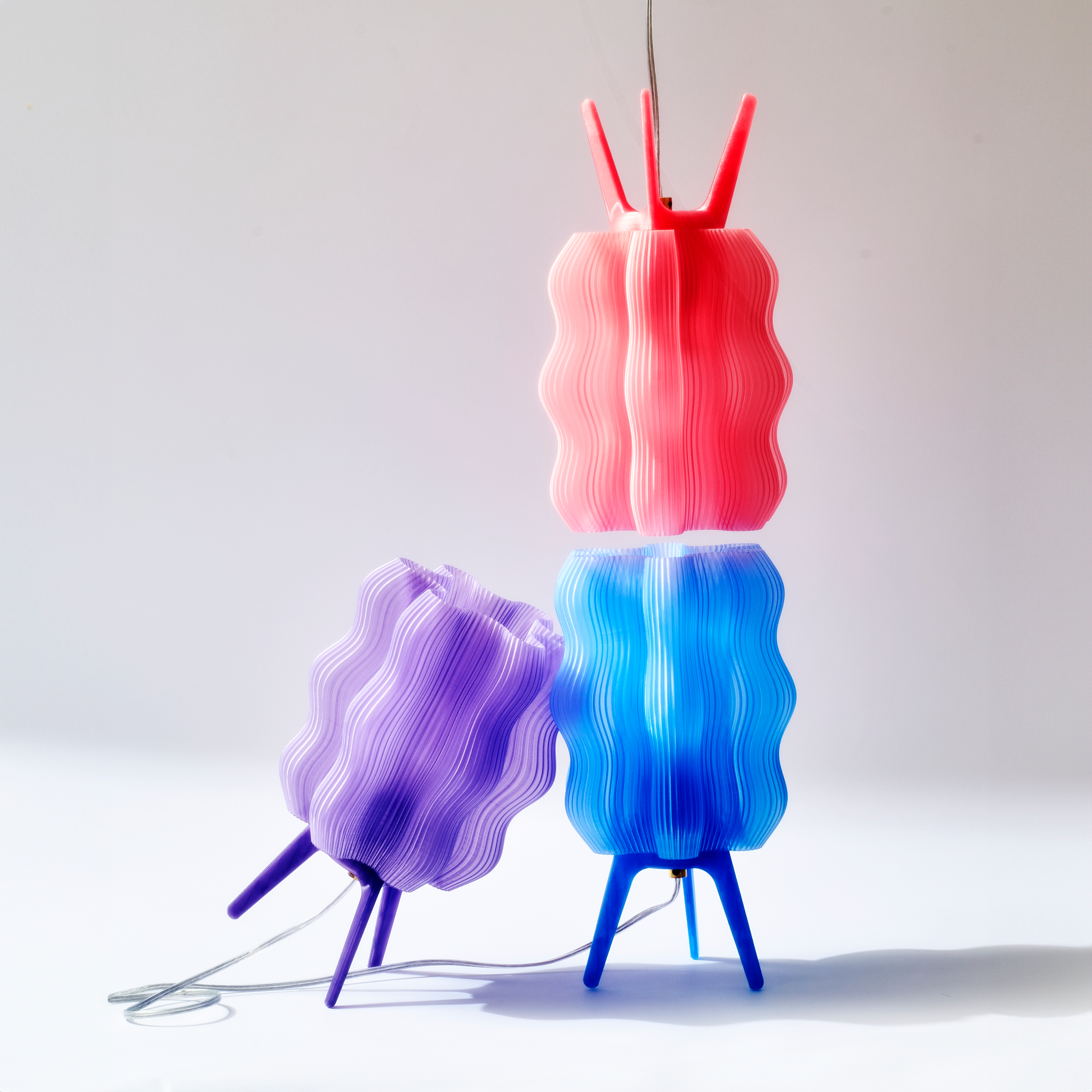 Wavy Lamps in peach, periwinkle, and lilac on white background