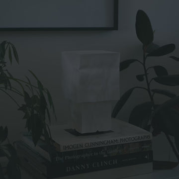 Farolito Lamp on stack of books turning on and off