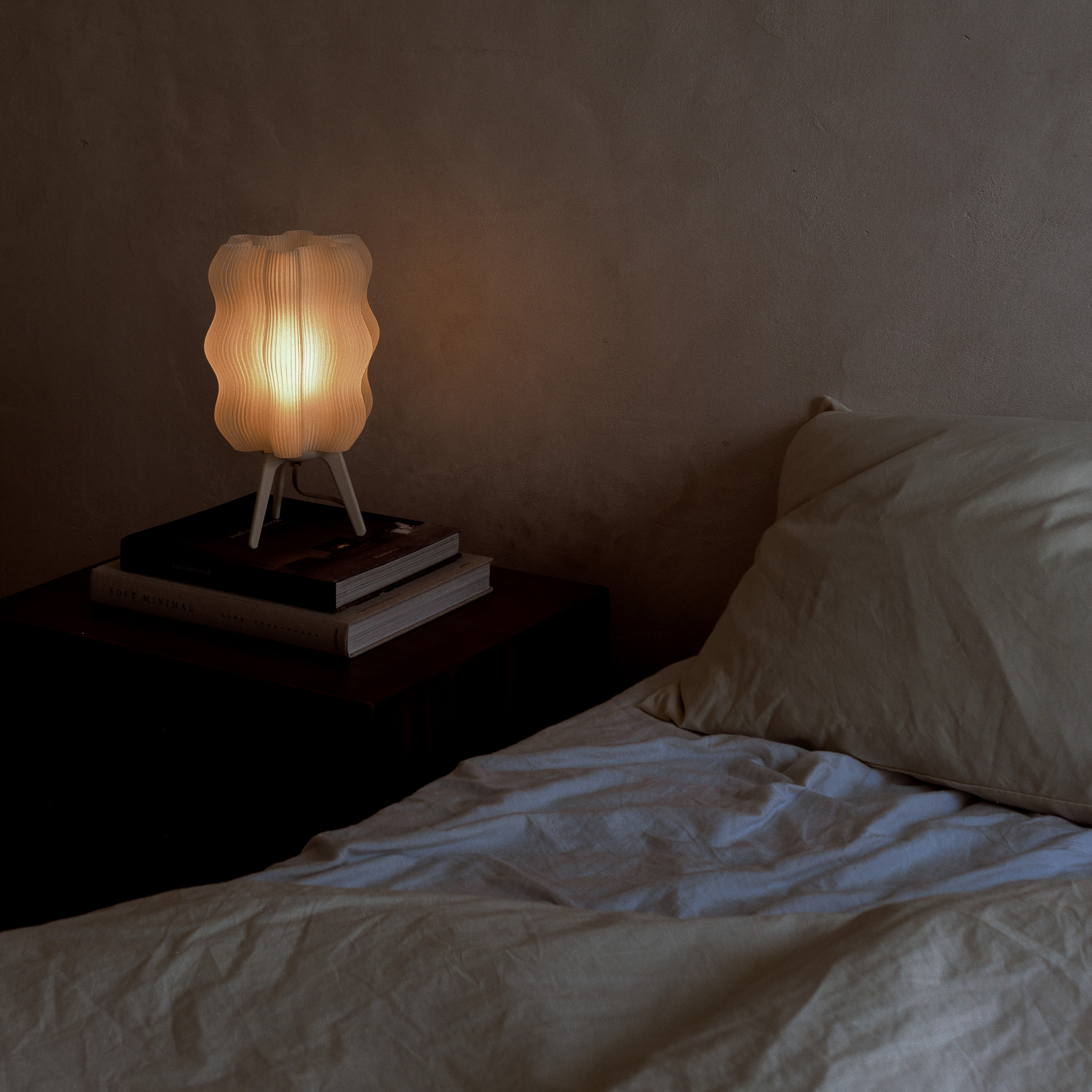 Wavy Lamp in eggshell on books on sidetable