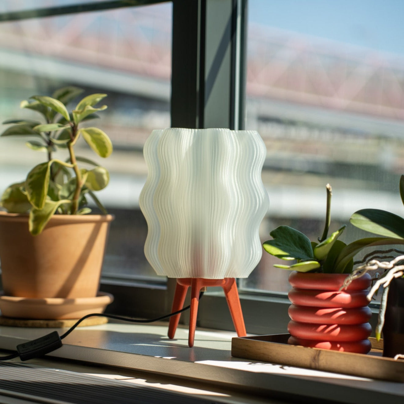 Wavy Lamp in vermillion on windowsill